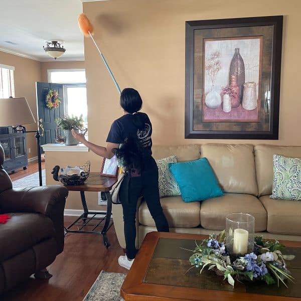Cleaning staff dusting walls and hard to reach places
