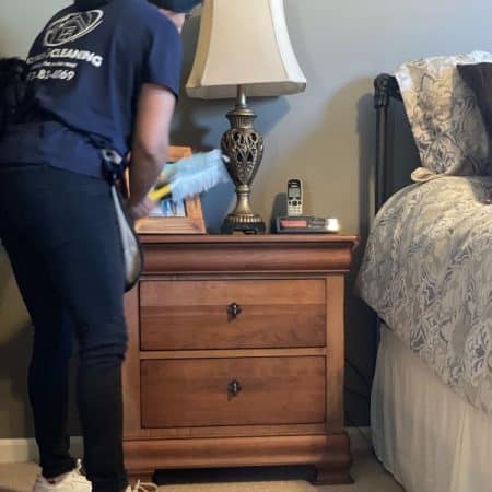 Staff employee cleaning bedroom
